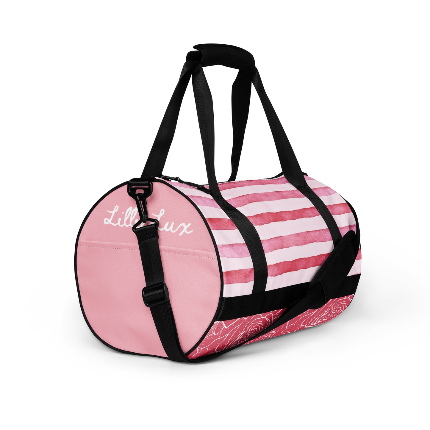 Lillielux ‘blush’ gym bag, front right angle, pink right panel and pocket, white logo detail on right panel, pink and white stripes top panel, pink and white rose pattern bottom panel, black straps, white background