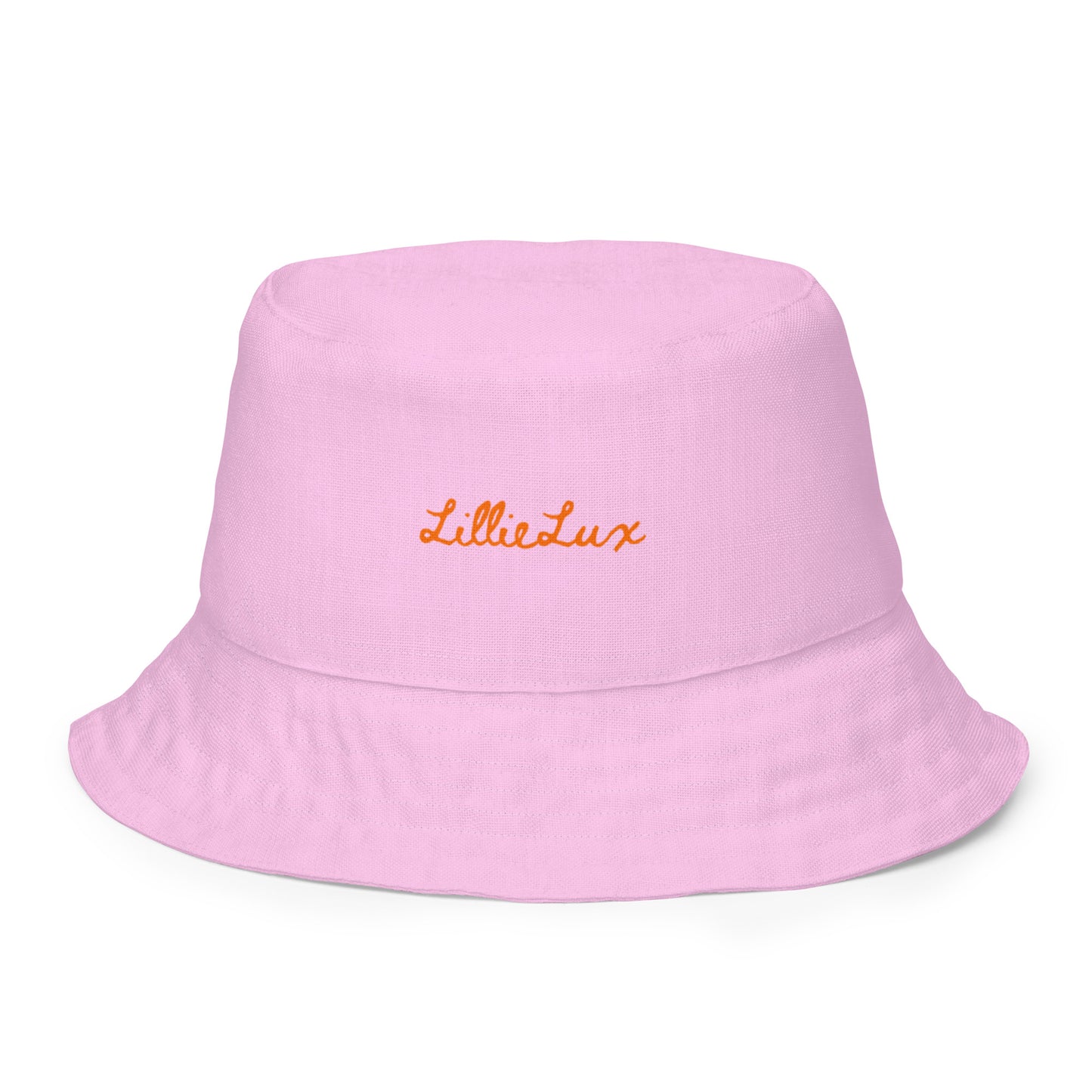 Front of reversible bucket hat in soft pastel pink, clean minimal finish.