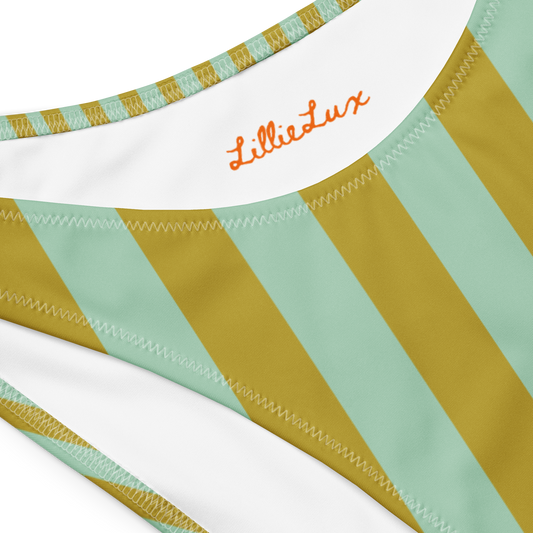 Close-up of Lillie Lux logo on Palm Tonic green striped bikini fabri