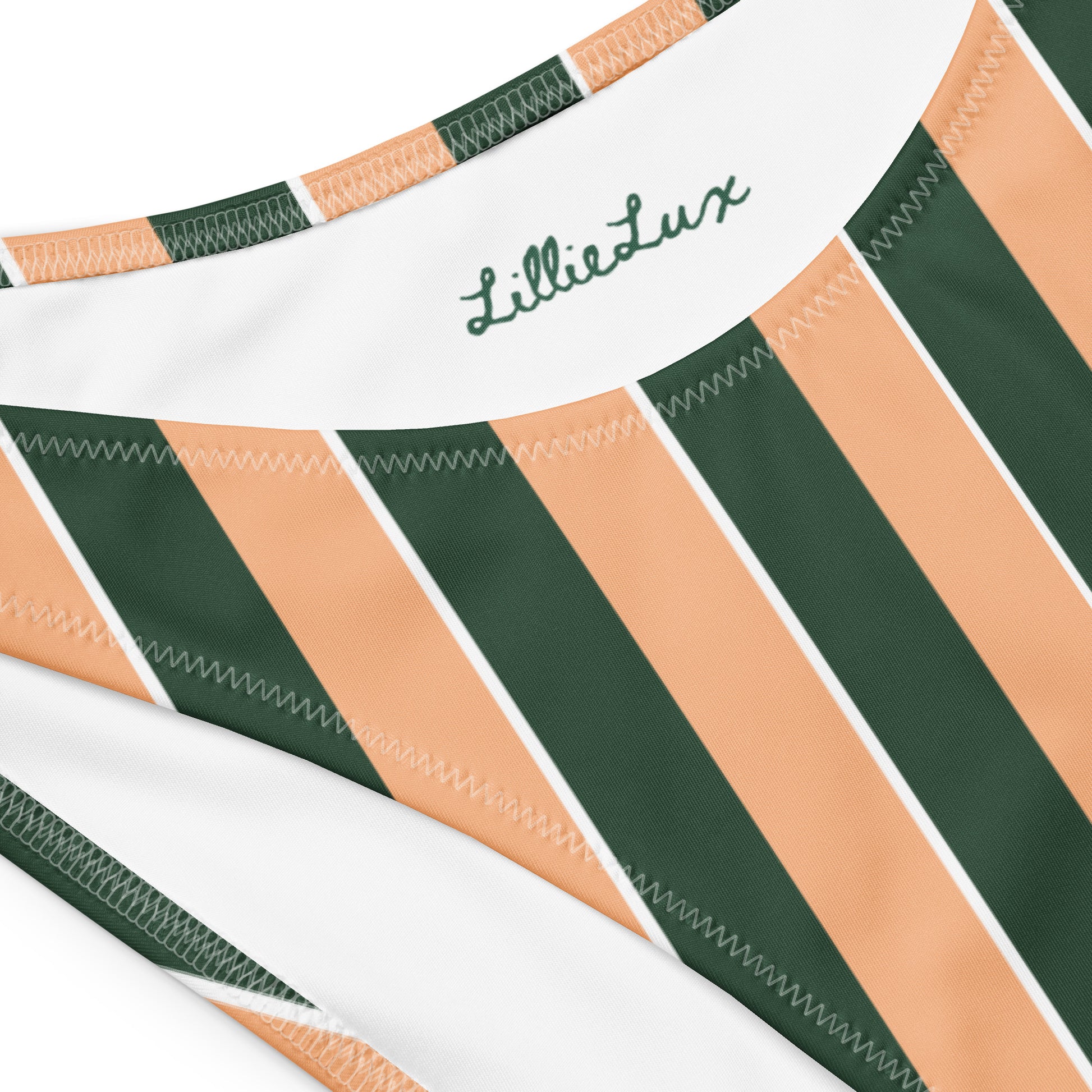Close-up of Lillie Lux logo on Sunset Stadium striped bikini top – eco swimwear