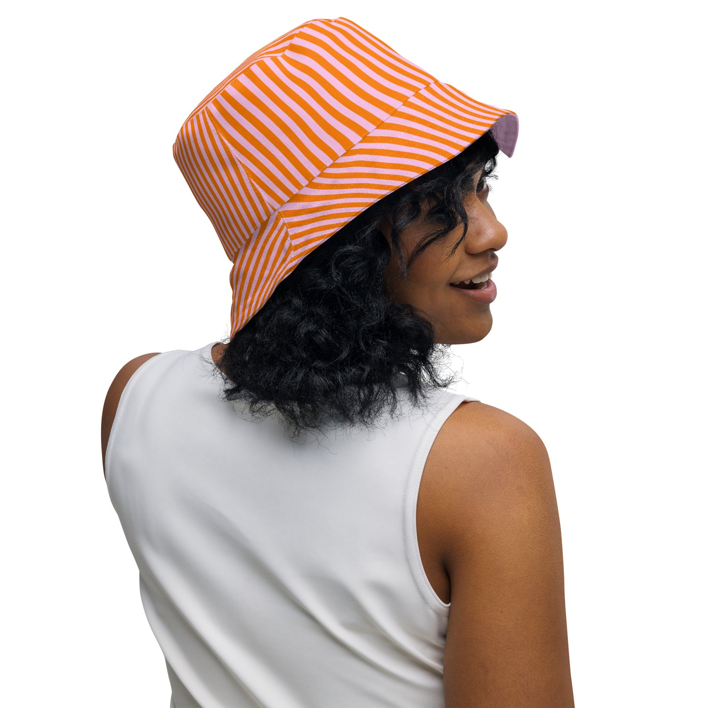 Woman wearing pink and orange Poppi print bucket hat outdoors, styled with sleeveless top.