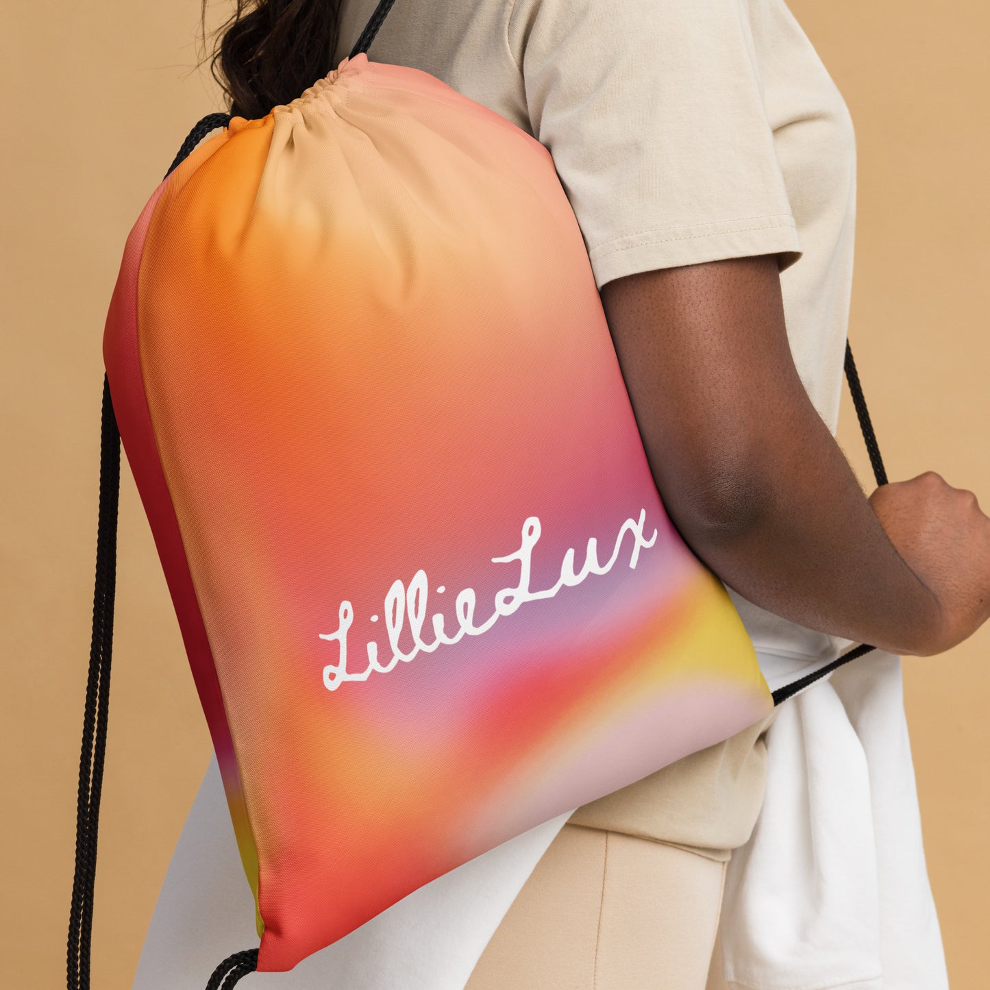 LillieLux solar, orange flair, drawstring bag, in use on African American model, white logo 